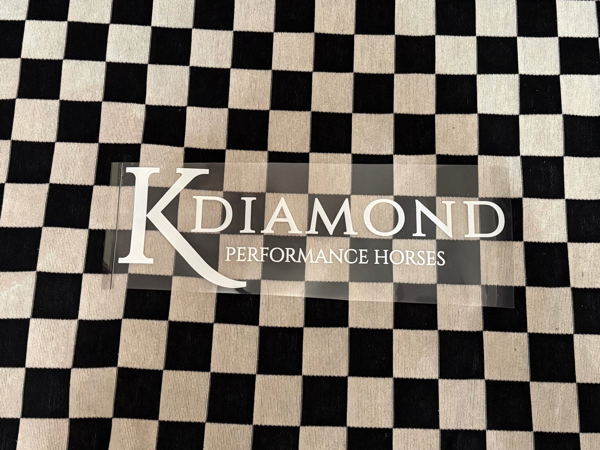 Black and white checkered towel with 'K Diamond' branding on a textured surface